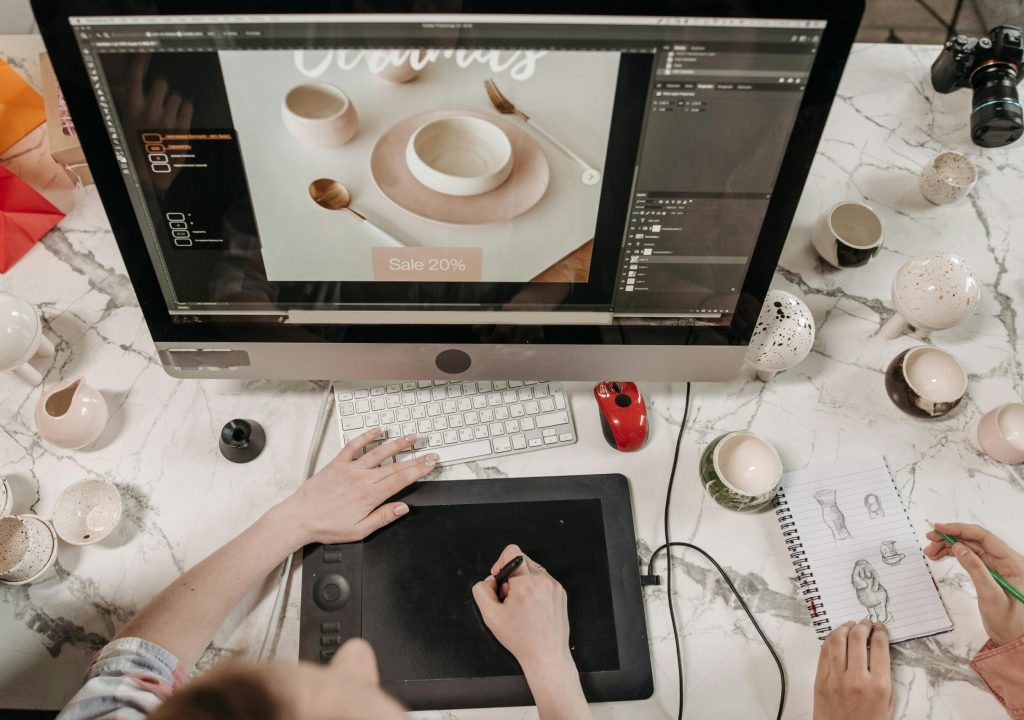 Overhead view of a creative workspace with design tools and sketches visible, ideal for teamwork and collaboration.